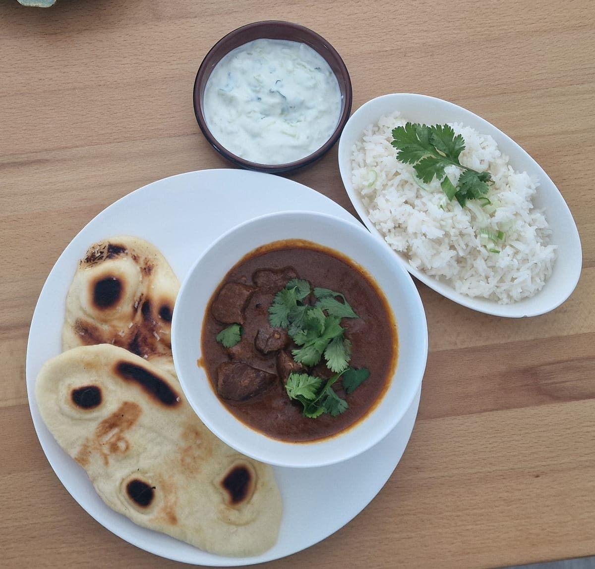 Beef rogan josh with naan, cucumber mint yoghurt and rice