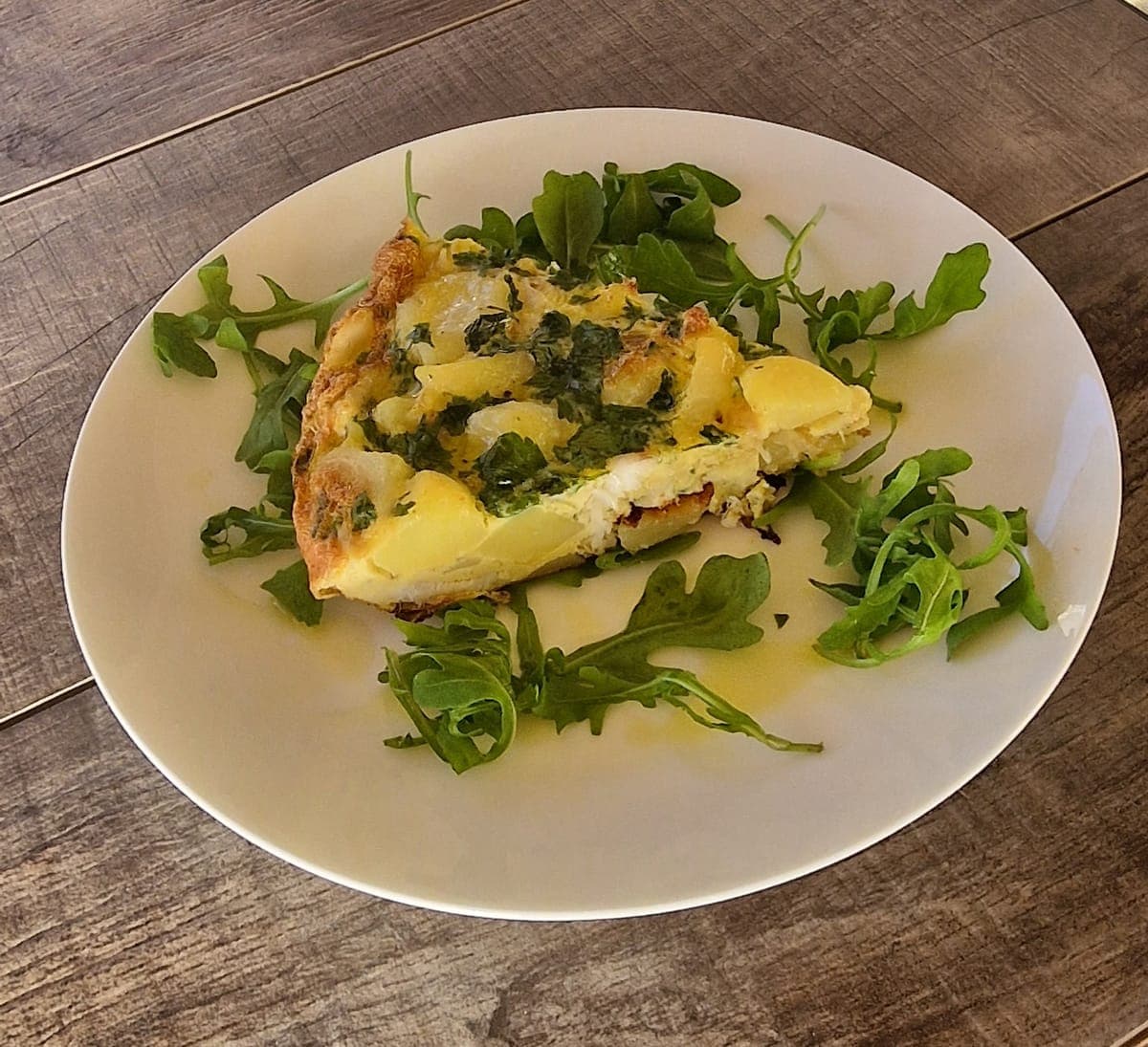 Cod tortilla on a bed of green salad