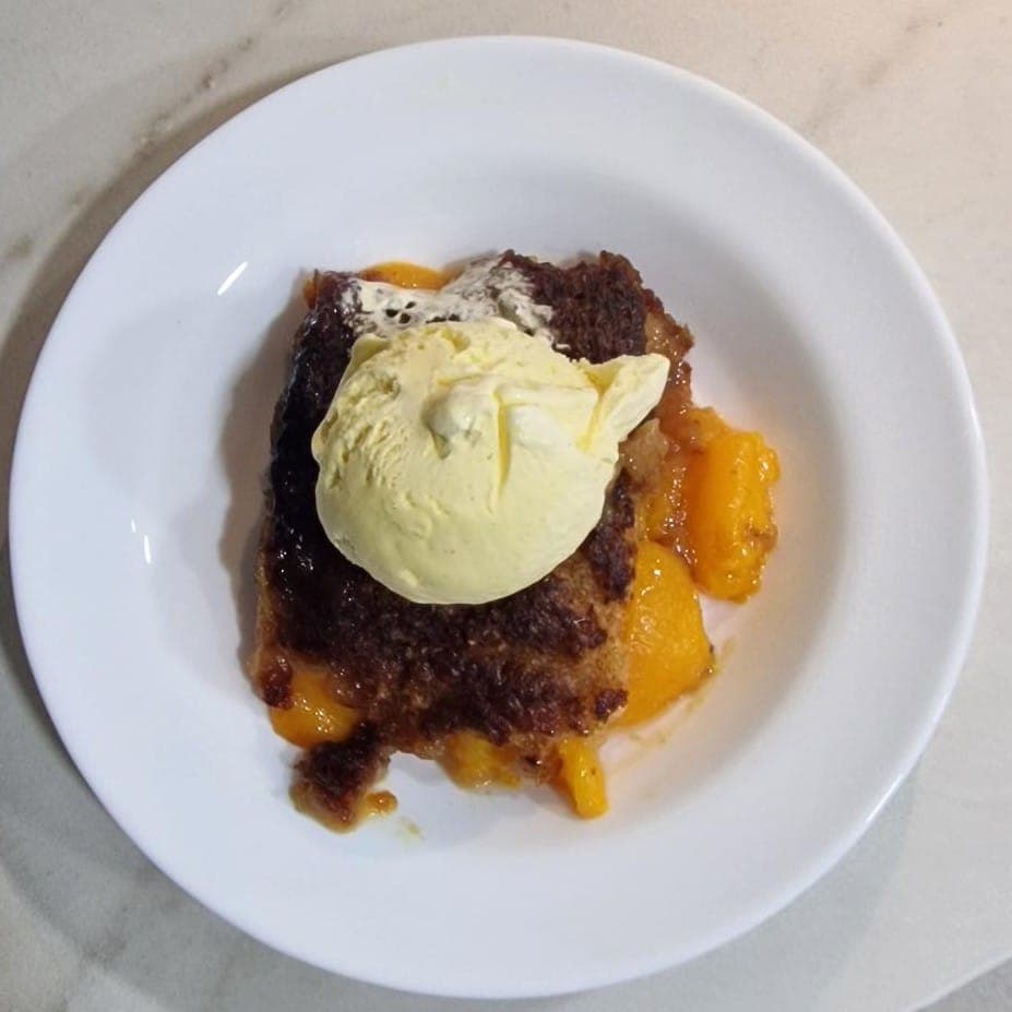 Peach cobbler with vanilla ice cream