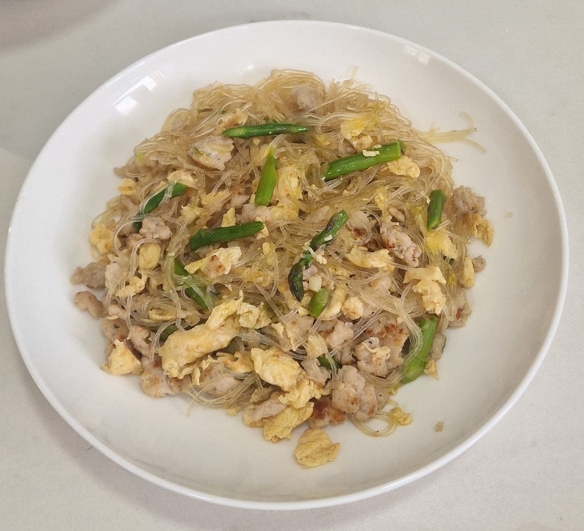 Thai stir-fried minced chicken and glass noodles with egg and asparagus