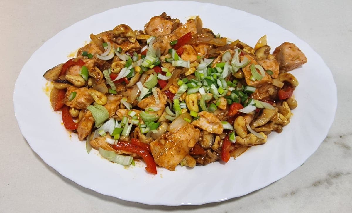 Thai stir fry cashew salmon with spring onions, served with jasmine rice